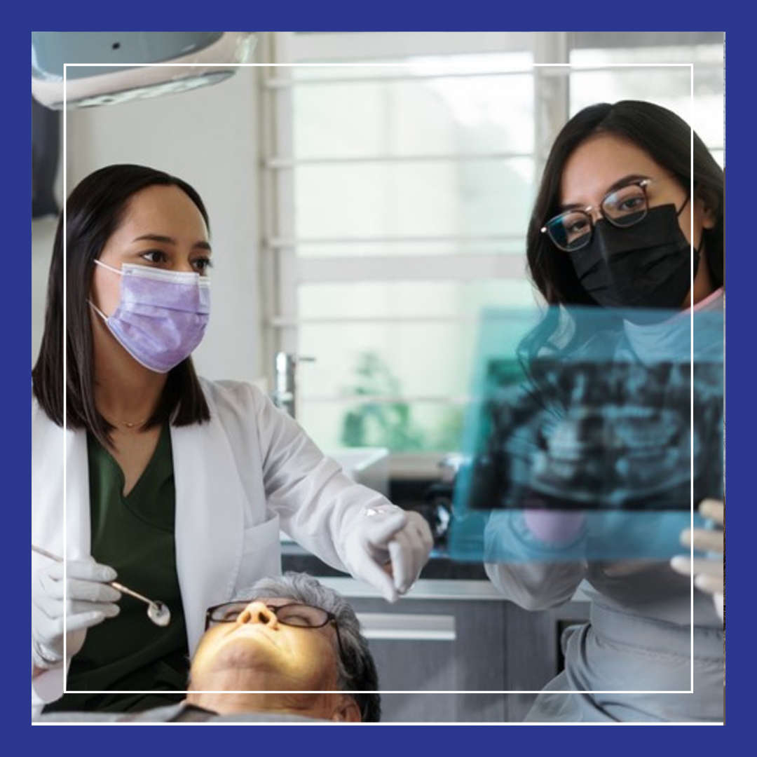 Dentist looking at X-ray